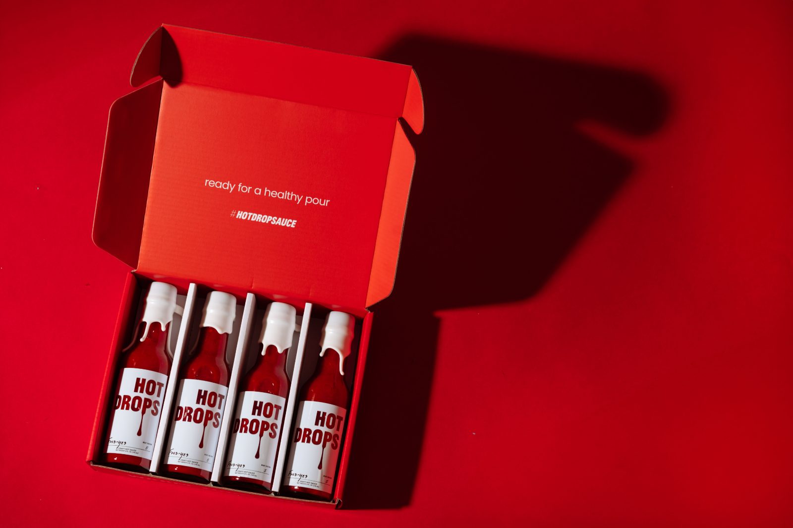 The mailer open, four bottles seated in the insert